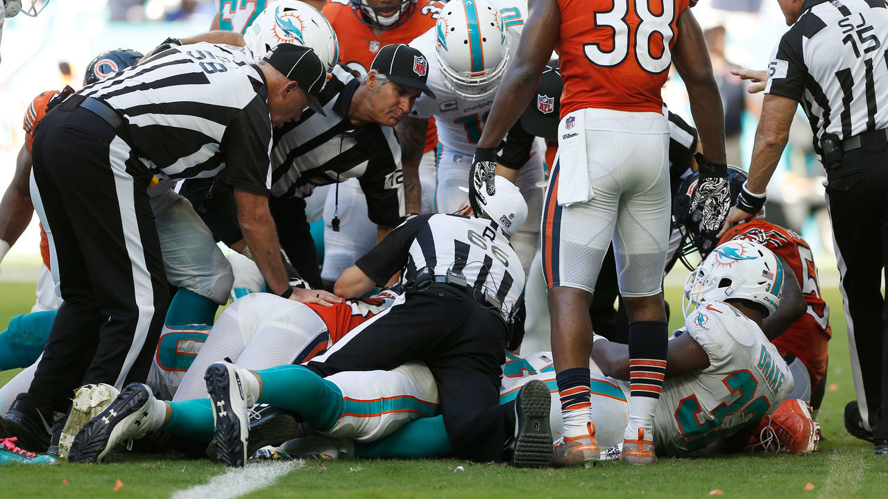 MIAMI, FL - OCTOBER 14: Kenyan Drake #32 of the Miami Dolphins reacts after fumbling a ball recovered by Eddie Goldman #91 of the Chicago Bears in overtime during the game at Hard Rock Stadium on October 14, 2018 in Miami, Florida.