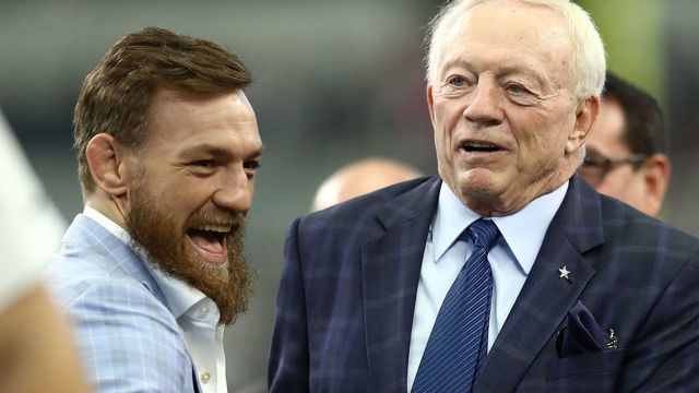 ARLINGTON, TX - OCTOBER 14: Conor McGregor visists with Dallas Cowboys owner Jerry Jones before the game against the Jacksonville Jaguars at AT&T Stadium on October 14, 2018 in Arlington, Texas.