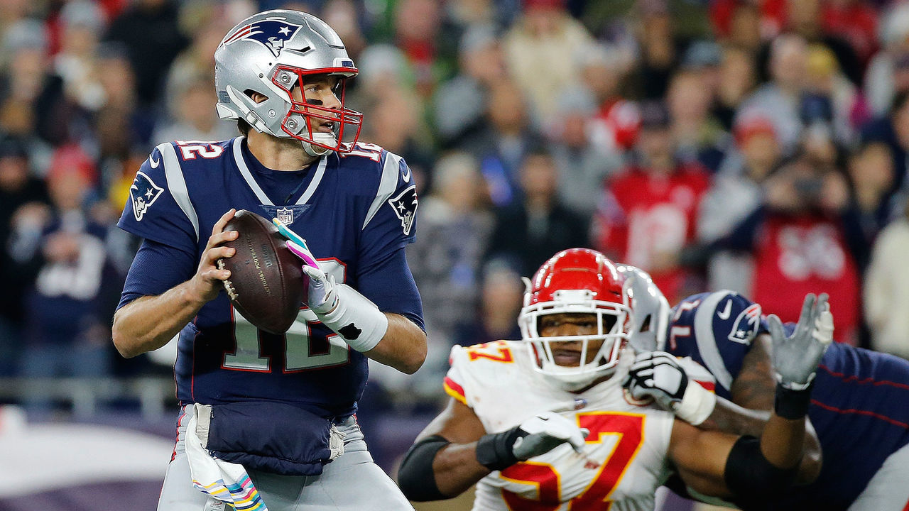 FOXBOROUGH, MA - OCTOBER 14: Tom Brady #12 of the New England Patriots feels the pressure of Breeland Speaks #57 of the Kansas City Chiefs in the fourth quarter at Gillette Stadium on October 14, 2018 in Foxborough, Massachusetts. Brady ran the ball in to the end zone for a touchdown on the play.