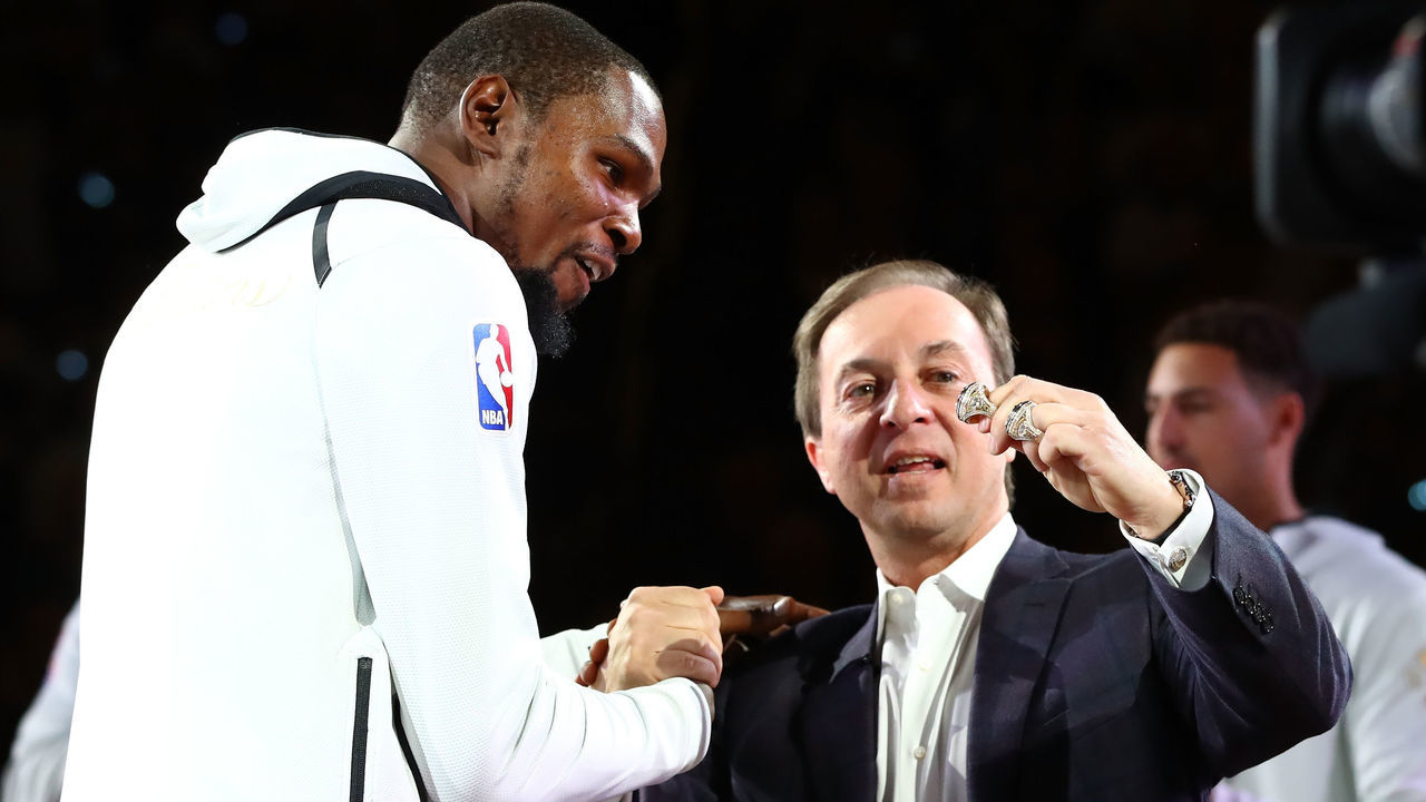 OAKLAND, CA - OCTOBER 17: Kevin Durant #35 of the Golden State Warriors receives his 2017 NBA Championship ring from team owner Joe Lacob prior to their NBA game against the Houston Rockets at ORACLE Arena on October 17, 2017 in Oakland, California.
