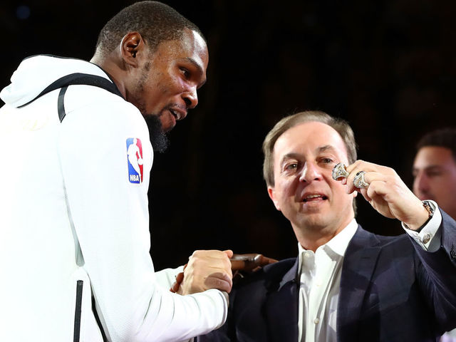 OAKLAND, CA - OCTOBER 17: Kevin Durant #35 of the Golden State Warriors receives his 2017 NBA Championship ring from team owner Joe Lacob prior to their NBA game against the Houston Rockets at ORACLE Arena on October 17, 2017 in Oakland, California.