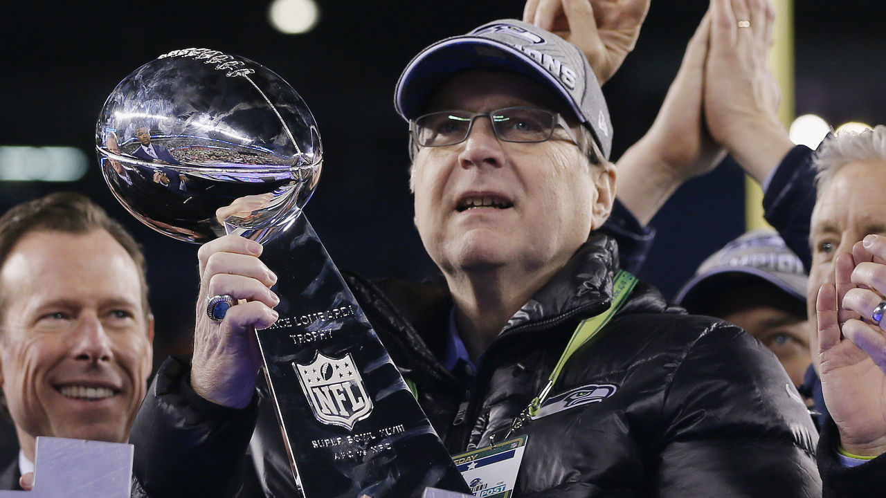 EAST RUTHERFORD, NJ - FEBRUARY 02: Team owner Paul Allen of the Seattle Seahawks celebrates with the Vince Lombardi trophy after defeating the Denver Broncos 43-8 in Super Bowl XLVIII at MetLife Stadium on February 2, 2014 in East Rutherford, New Jersey.
