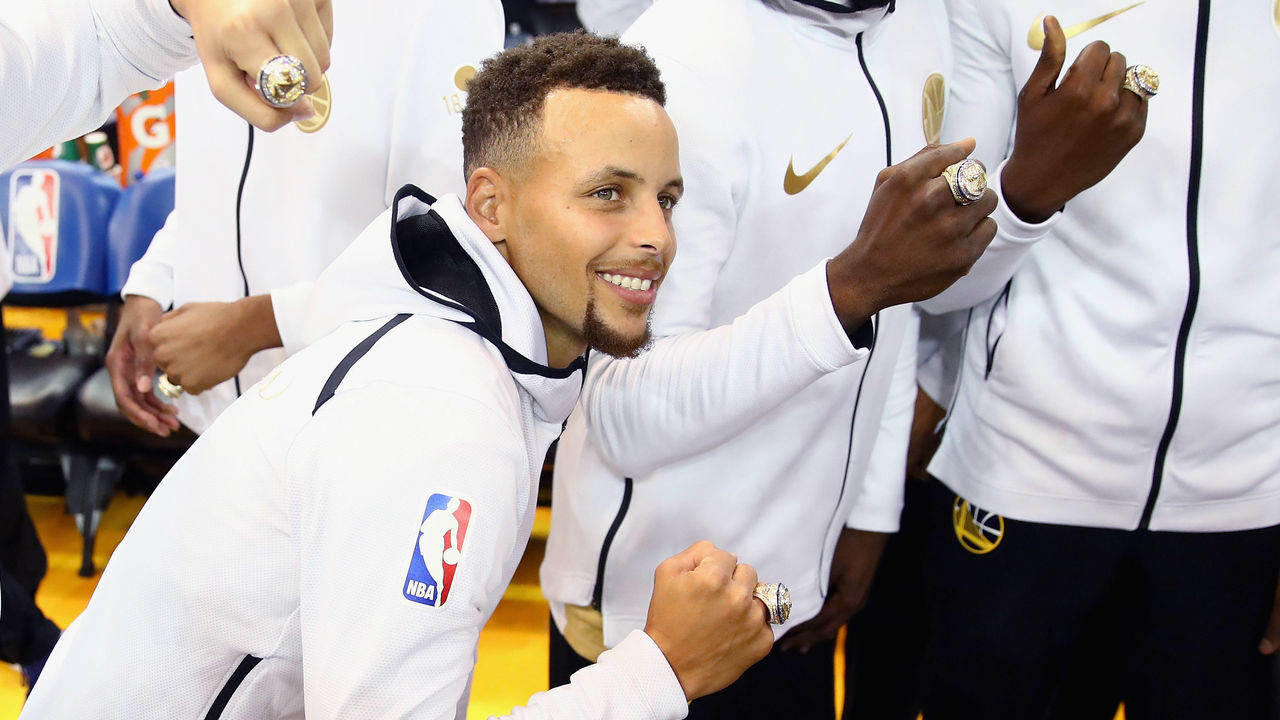 OAKLAND, CA - OCTOBER 17: Stephen Curry #30 of the Golden State Warriors shows off his championship ring before their game against the Houston Rockets at ORACLE Arena on October 17, 2017 in Oakland, California.