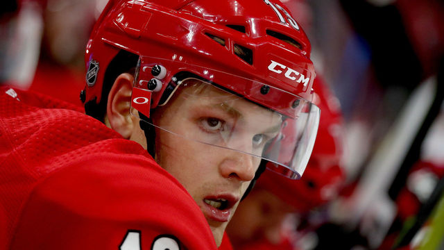 RALEIGH, NC - OCTOBER 9: Warren Foegele #13 of the Carolina Hurricanes watches action on the ice during an NHL game against the Vancouver Canucks on October 9, 2018 at PNC Arena in Raleigh, North Carolina.
