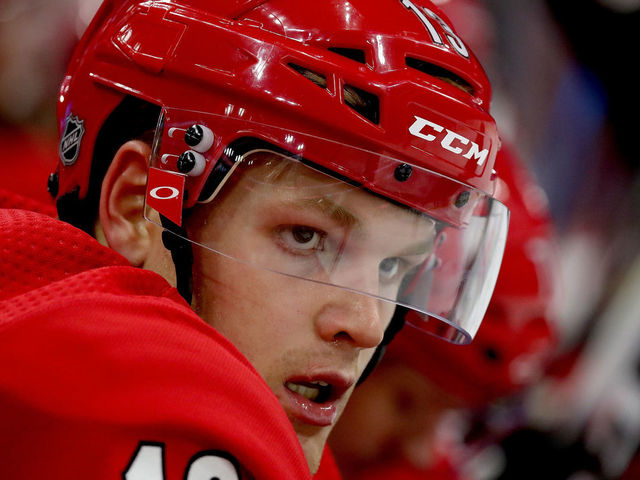 RALEIGH, NC - OCTOBER 9: Warren Foegele #13 of the Carolina Hurricanes watches action on the ice during an NHL game against the Vancouver Canucks on October 9, 2018 at PNC Arena in Raleigh, North Carolina.