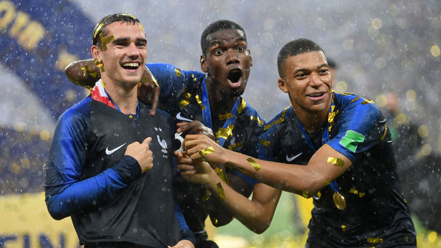 MOSCOW, RUSSIA - JULY 15: Antoine Griezmann, Paul Pogba, and Kylian Mbappe of France celebrate following their sides victory in the 2018 FIFA World Cup Final between France and Croatia at Luzhniki Stadium on July 15, 2018 in Moscow, Russia.