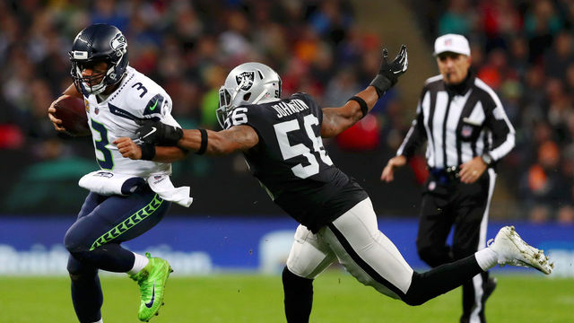 LONDON, ENGLAND - OCTOBER 14: Derrick Johnson of Oakland Raiders tackles Russell Wilson during the NFL International series match between Seattle Seahawks and Oakland Raiders at Wembley Stadium on October 14, 2018 in London, England.