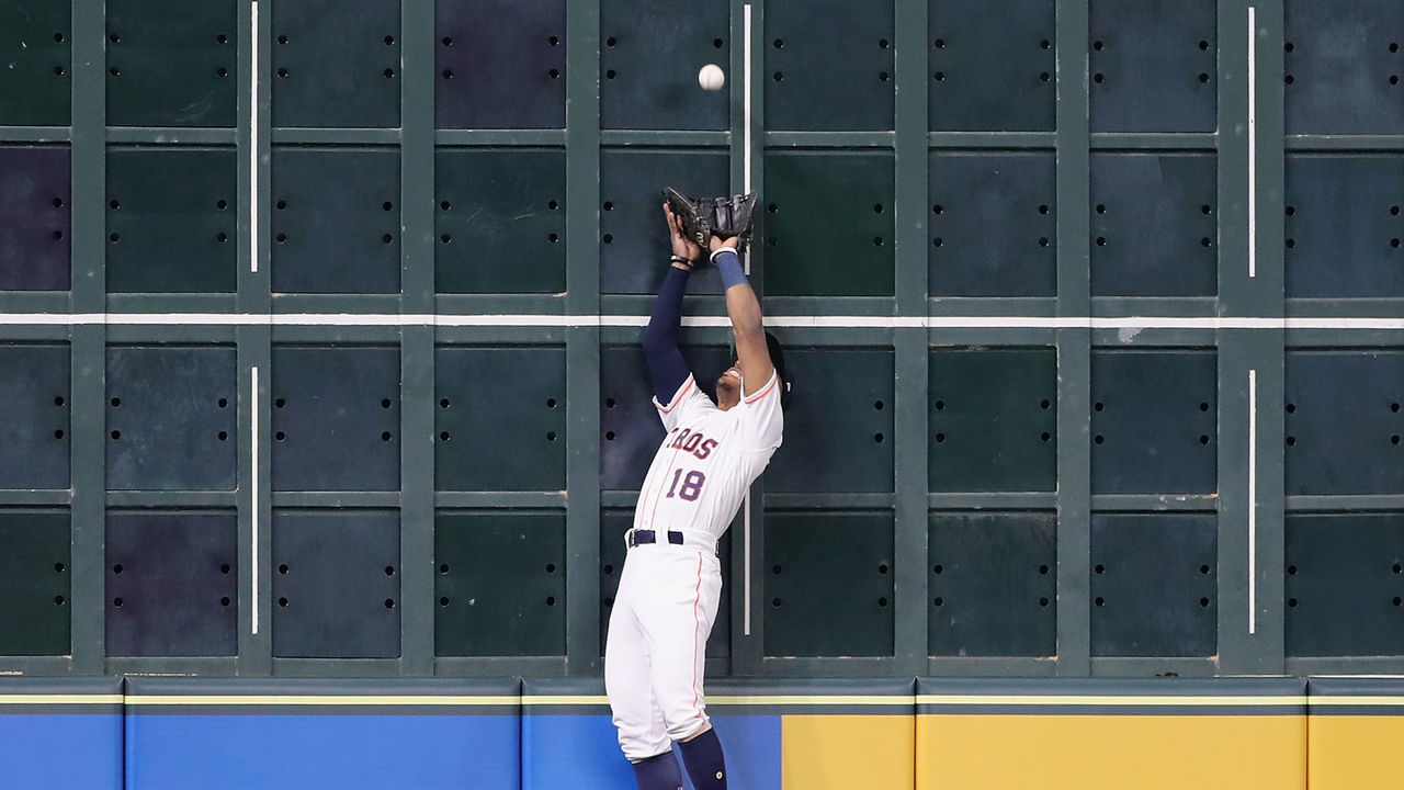 HOUSTON, TX - OCTOBER 16: Tony Kemp #18 of the Houston Astros catches a deep fly ball against the left field wall in the third inning against the Boston Red Sox during Game Three of the American League Championship Series at Minute Maid Park on October 16, 2018 in Houston, Texas.