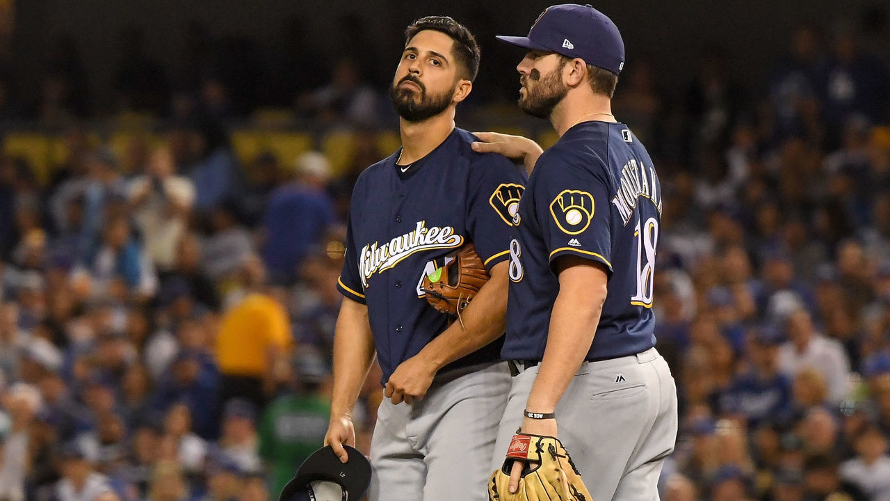 LOS ANGELES, CA - OCTOBER 16: Gio Gonzalez #47 of the Milwaukee Brewers reacts with Mike Moustakas #18 after he was injured during the second inning against the Los Angeles Dodgers in Game Four of the National League Championship Series at Dodger Stadium on October 16, 2018 in Los Angeles, California.