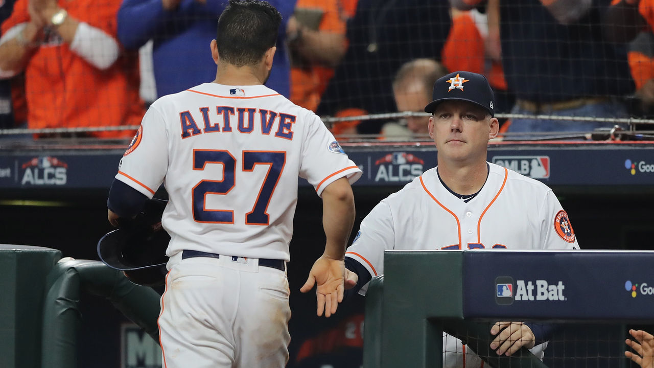 HOUSTON, TX - OCTOBER 16: Jose Altuve #27 of the Houston Astros celebrates with manager AJ Hinch after scoring a run in the first inning against the Boston Red Sox during Game Three of the American League Championship Series at Minute Maid Park on October 16, 2018 in Houston, Texas.