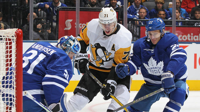 TORONTO, ON - OCTOBER 18: Evgeni Malkin #71 of the Pittsburgh Penguins squeezes between Frederik Andersen #31 and Nikita Zaitsev #22 of the Toronto Maple Leafs during an NHL game at Scotiabank Arena on October 18, 2018 in Toronto, Ontario, Canada.