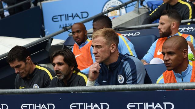 Manchester City's English goalkeeper Joe Hart (2R) sits on the substitutes bench for the English Premier League football match between Manchester City and Sunderland at the Etihad Stadium in Manchester, north west England, on August 13, 2016. Manchester City manager Pep Guardiola dropped goalkeeper Joe Hart in favour of Willy Caballero for his opening Premier League game against Sunderland on August 13. / AFP / PAUL ELLIS /