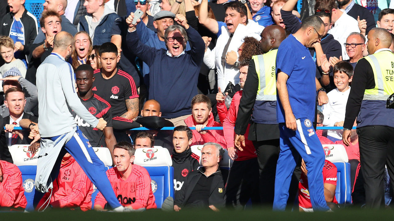LONDON, ENGLAND - OCTOBER 20: A member of the backroom staff at Chelsea celebrates his sides second goal infront of Jose Mourinho, Manager of Manchester Unied during the Premier League match between Chelsea FC and Manchester United at Stamford Bridge on October 20, 2018 in London, United Kingdom.