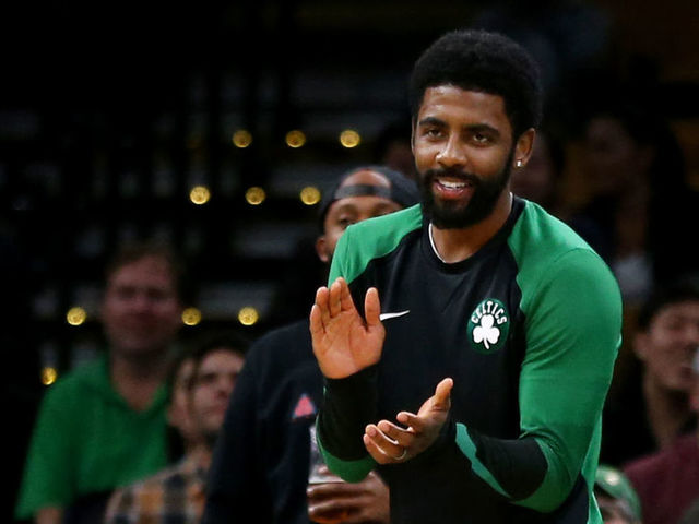 BOSTON, MA - OCTOBER 2: Kyrie Irving #11 of the Boston Celtics cheers from the sideline during the preseason game against the Cleveland Cavaliers at TD Garden on October 2, 2018 in Boston, Massachusetts.