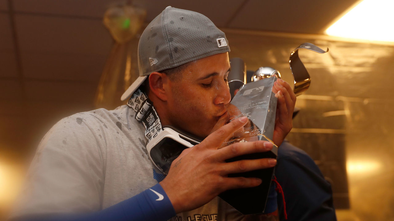 MILWAUKEE, WI - OCTOBER 20: Manny Machado #8 of the Los Angeles Dodgers celebrates with the Warren C. Giles Trophy in the locker room after defeating the Milwaukee Brewers in Game Seven to win the National League Championship Series at Miller Park on October 20, 2018 in Milwaukee, Wisconsin.