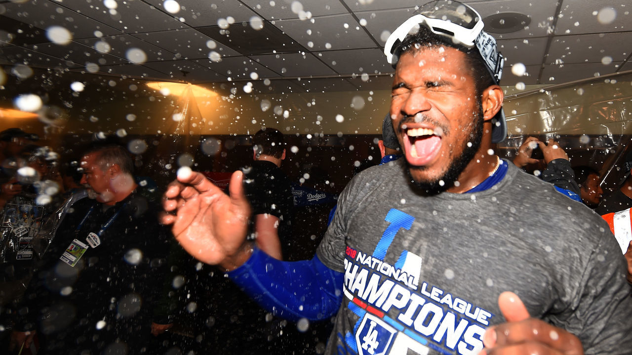 MILWAUKEE, WI - OCTOBER 20: Yasiel Puig #66 of the Los Angeles Dodgers celebrates in the locker room after defeating the Milwaukee Brewers in Game Seven to win the National League Championship Series at Miller Park on October 20, 2018 in Milwaukee, Wisconsin.