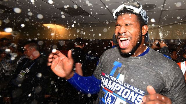 MILWAUKEE, WI - OCTOBER 20: Yasiel Puig #66 of the Los Angeles Dodgers celebrates in the locker room after defeating the Milwaukee Brewers in Game Seven to win the National League Championship Series at Miller Park on October 20, 2018 in Milwaukee, Wisconsin.