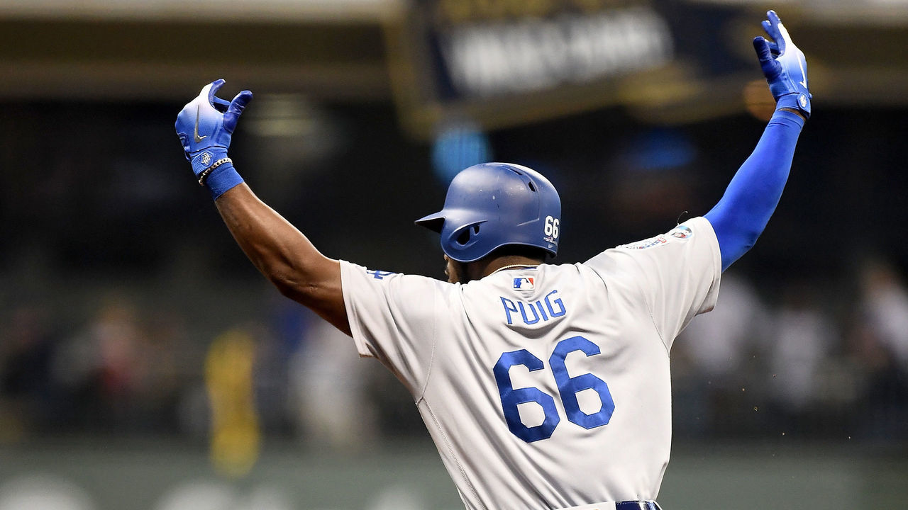 MILWAUKEE, WI - OCTOBER 20: Yasiel Puig #66 of the Los Angeles Dodgers celebrates after hitting a three run home run against Jeremy Jeffress #32 of the Milwaukee Brewers during the sixth inning in Game Seven of the National League Championship Series at Miller Park on October 20, 2018 in Milwaukee, Wisconsin.