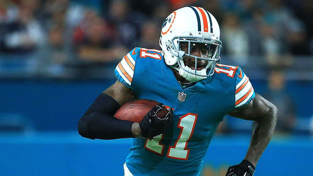 MIAMI GARDENS, FL - DECEMBER 11: DeVante Parker #11 of the Miami Dolphins carries the ball against the New England Patriots during the first quarter at Hard Rock Stadium on December 11, 2017 in Miami Gardens, Florida.