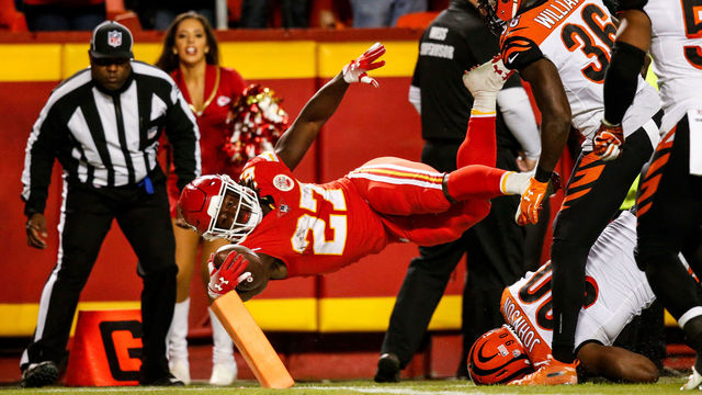 KANSAS CITY, MO - OCTOBER 21: Kareem Hunt #27 of the Kansas City Chiefs dives across the goal line for the second touchdown of the game during the second quarter of the game against the Cincinnati Bengals at Arrowhead Stadium on October 21, 2018 in Kansas City, Kansas.