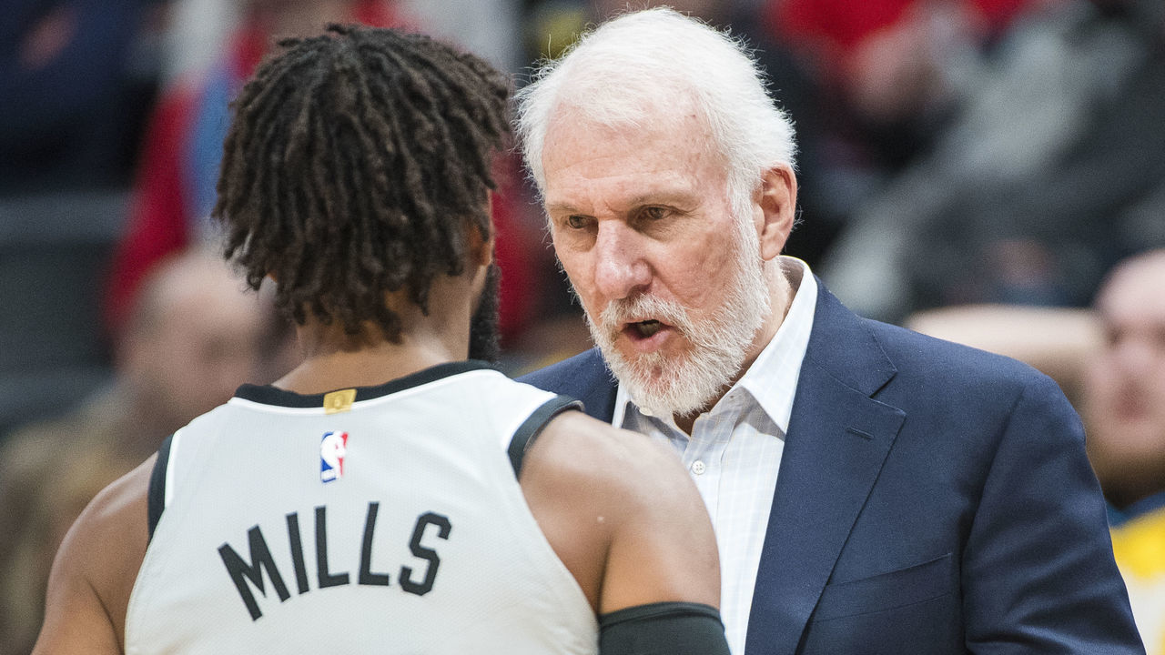 DENVER, CO - FEBRUARY 23: Gregg Popovich of the San Antonio Spurs speaks with Patty Mills #8 against the Denver Nuggets at Pepsi Center on February 23, 2018 in Denver, Colorado.