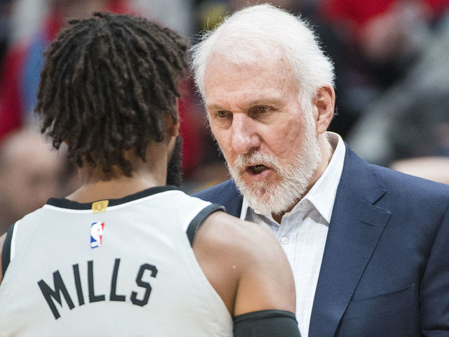 DENVER, CO - FEBRUARY 23: Gregg Popovich of the San Antonio Spurs speaks with Patty Mills #8 against the Denver Nuggets at Pepsi Center on February 23, 2018 in Denver, Colorado.