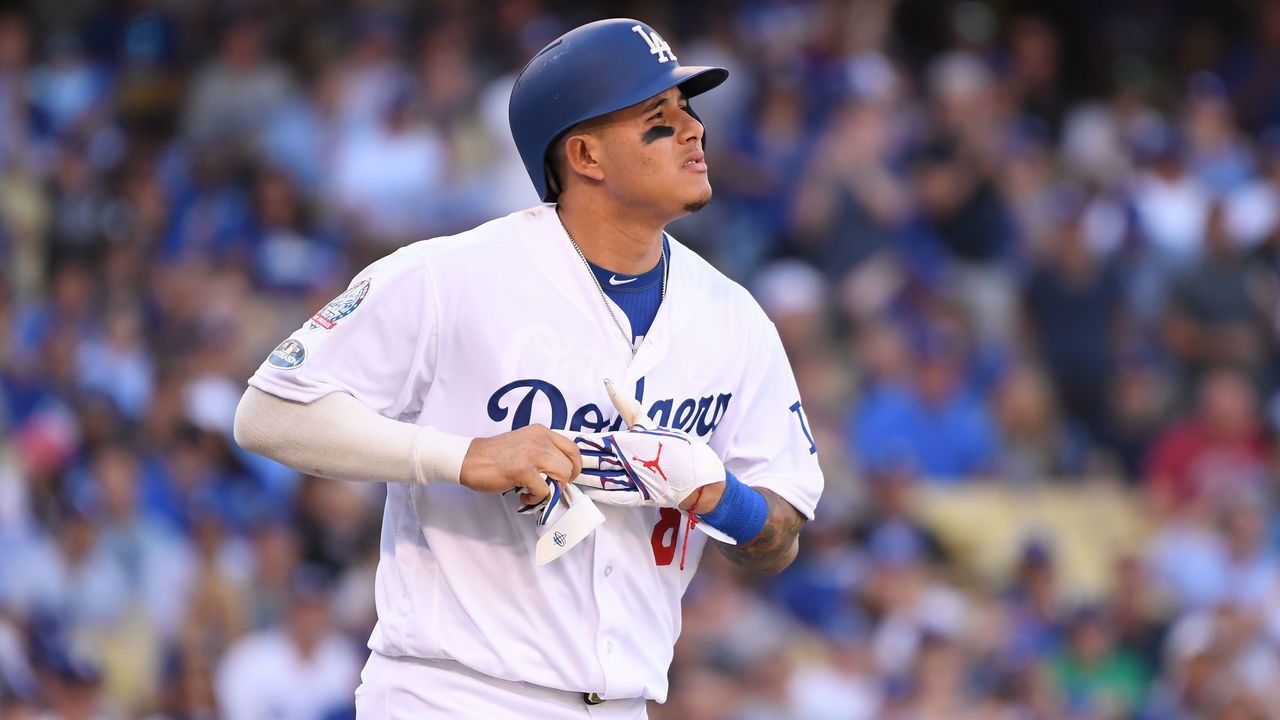 LOS ANGELES, CA - OCTOBER 17: Manny Machado #8 of the Los Angeles Dodgers jogs to first base after being hit by a pitch in the sixth inning during Game Five of the National League Championship Series against the Milwaukee Brewers at Dodger Stadium on October 17, 2018 in Los Angeles, California.