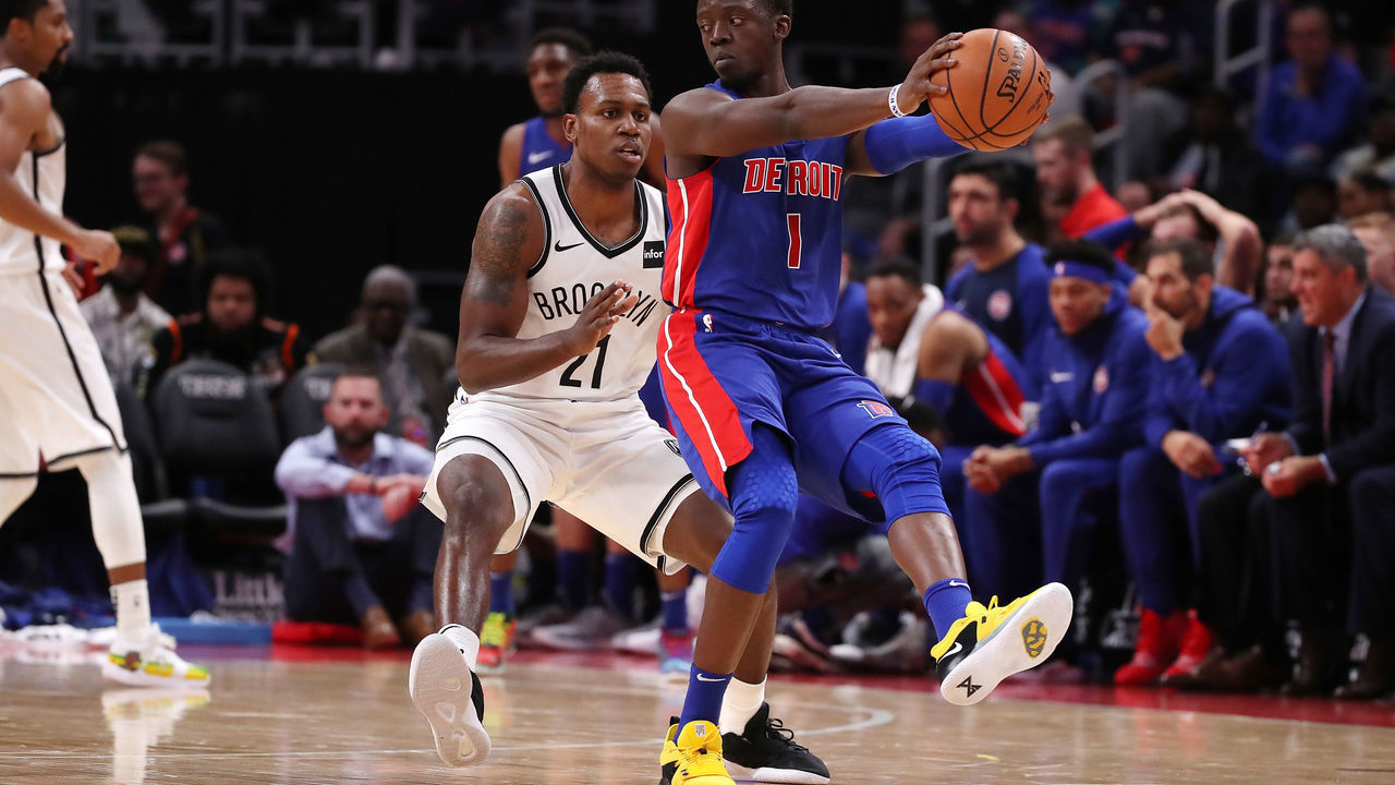 DETROIT, MI - OCTOBER 17: Reggie Jackson #1 of the Detroit Pistons controls the ball in front of Treveon Graham #21 of the Brooklyn Nets in the second half during the home opener at Little Caesars Arena on October 17, 2018 in Detroit, Michigan.