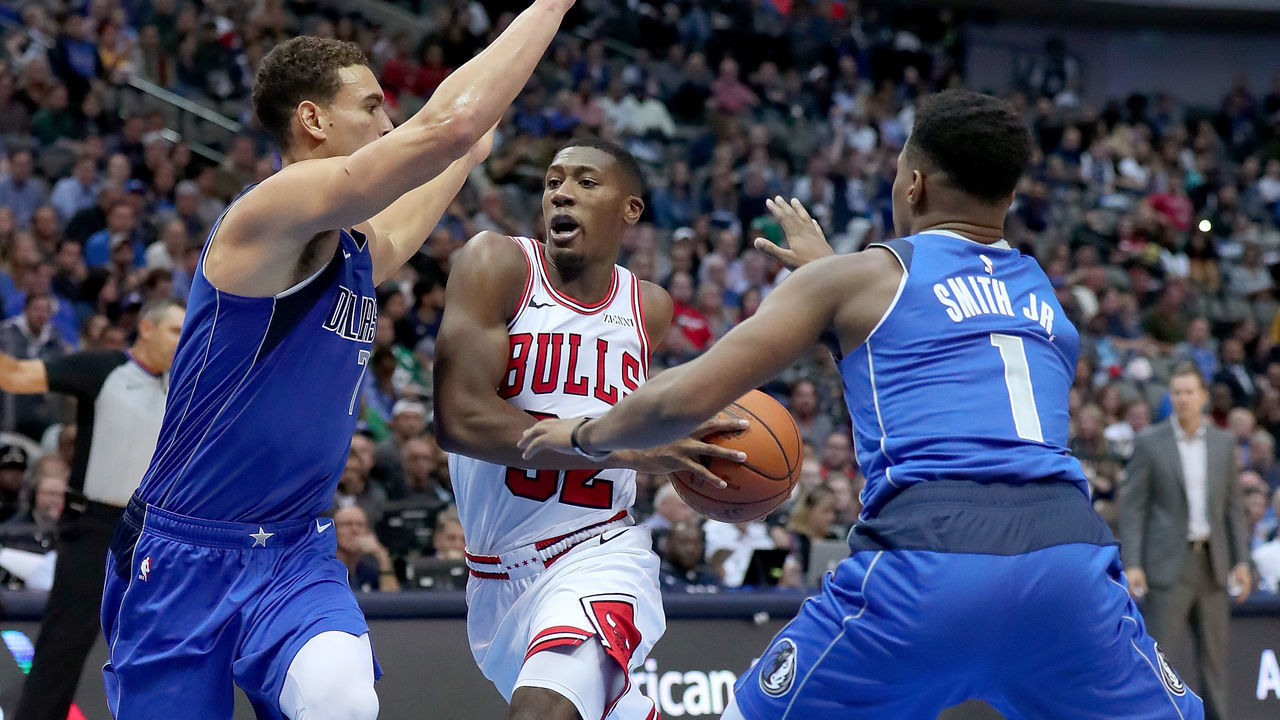 DALLAS, TX - OCTOBER 22: Kris Dunn #32 of the Chicago Bulls drives to the basket against Dwight Powell #7 of the Dallas Mavericks and Dennis Smith Jr. #1 of the Dallas Mavericks in the second half at American Airlines Center on October 22, 2018 in Dallas, Texas.
