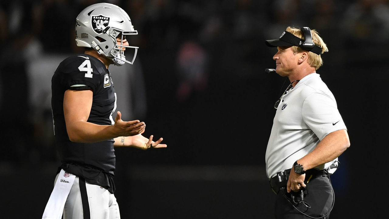 OAKLAND, CA - SEPTEMBER 10: Derek Carr #4 of the Oakland Raiders speaks with head coach Jon Gruden during their NFL game against the Los Angeles Rams at Oakland-Alameda County Coliseum on September 10, 2018 in Oakland, California.