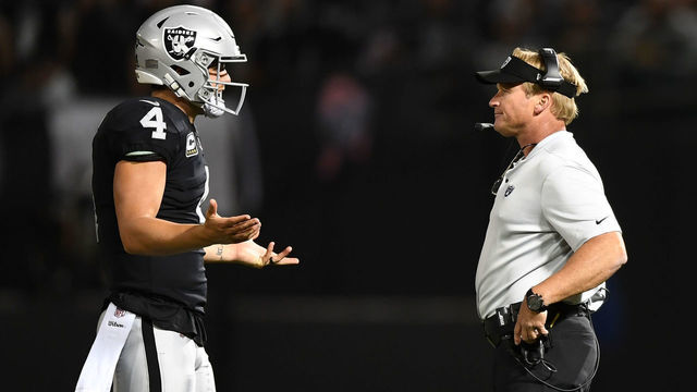 OAKLAND, CA - SEPTEMBER 10: Derek Carr #4 of the Oakland Raiders speaks with head coach Jon Gruden during their NFL game against the Los Angeles Rams at Oakland-Alameda County Coliseum on September 10, 2018 in Oakland, California.