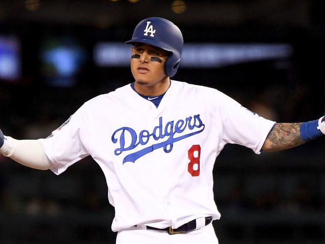 LOS ANGELES, CA - OCTOBER 15: Manny Machado #8 of the Los Angeles Dodgers reacts after hitting a double during the ninth inning against the Milwaukee Brewers in Game Three of the National League Championship Series at Dodger Stadium on October 15, 2018 in Los Angeles, California.