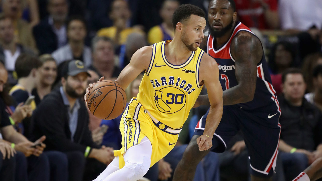 OAKLAND, CA - OCTOBER 24: Stephen Curry #30 of the Golden State Warriors is guarded by John Wall #2 of the Washington Wizards at ORACLE Arena on October 24, 2018 in Oakland, California.