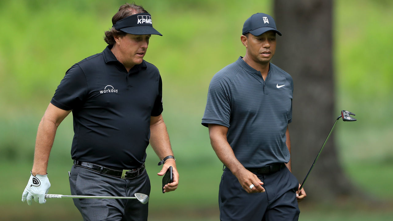 AKRON, OH - AUGUST 01: Phil Mickelson (L) and Tiger Woods meet during a preview day of the World Golf Championships - Bridgestone Invitational at Firestone Country Club South Course at on August 1, 2018 in Akron, Ohio.