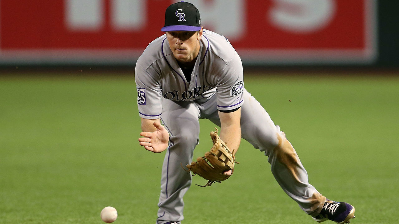 PHOENIX, AZ - SEPTEMBER 22: Second baseman DJ LeMahieu #9 of the Colorado Rockies fields a ground ball against the Arizona Diamondbacks during the ninth inning of an MLB game at Chase Field on September 22, 2018 in Phoenix, Arizona.