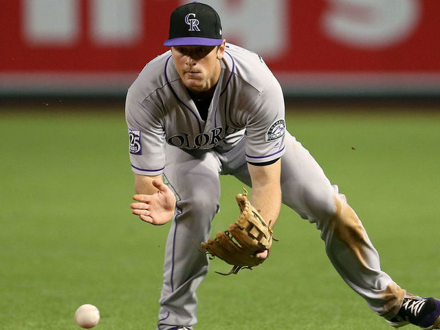 PHOENIX, AZ - SEPTEMBER 22: Second baseman DJ LeMahieu #9 of the Colorado Rockies fields a ground ball against the Arizona Diamondbacks during the ninth inning of an MLB game at Chase Field on September 22, 2018 in Phoenix, Arizona.