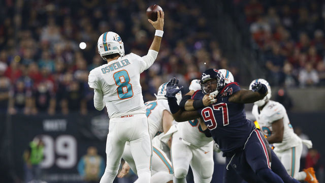 HOUSTON, TX - OCTOBER 25: Brock Osweiler #8 of the Miami Dolphins throws a pass pressured by Angelo Blackson #97 of the Houston Texans in first quarter at NRG Stadium on October 25, 2018 in Houston, Texas.