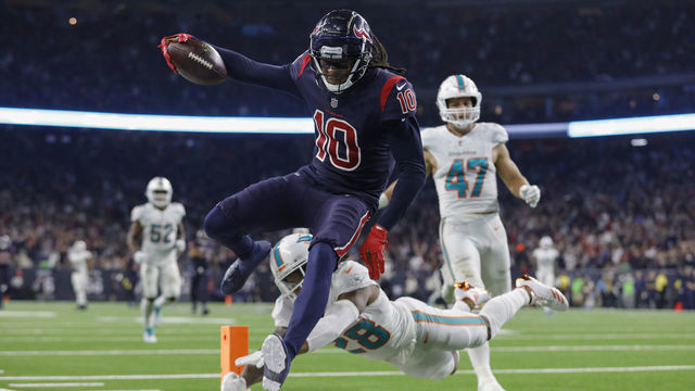 HOUSTON, TX - OCTOBER 25: DeAndre Hopkins #10 of the Houston Texans catches a pass and runs for a touchdown in the fourth quarter defended by Bobby McCain #28 of the Miami Dolphins at NRG Stadium on October 25, 2018 in Houston, Texas.