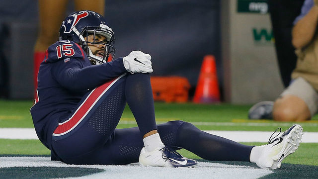 HOUSTON, TX - OCTOBER 25: Will Fuller V #15 of the Houston Texans holds his right knee after landing hard on the turf in the fourth quarter Houston Texans at NRG Stadium on October 25, 2018 in Houston, Texas.