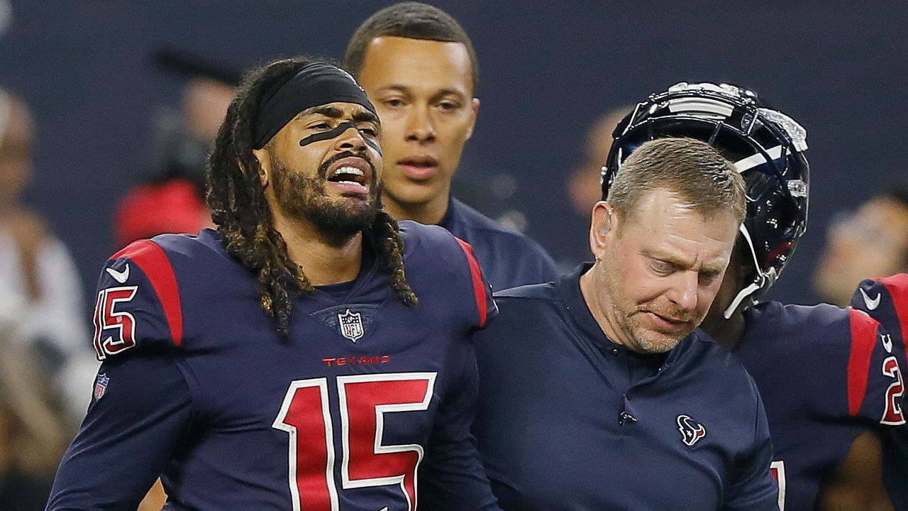 HOUSTON, TX - OCTOBER 25: Will Fuller V #15 of the Houston Texans is helped off the field in the fourth quarter after landing hard on his right knee against the Miami Dolphins at NRG Stadium on October 25, 2018 in Houston, Texas.