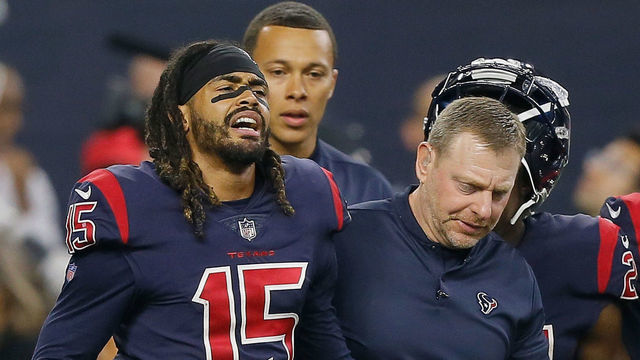 HOUSTON, TX - OCTOBER 25: Will Fuller V #15 of the Houston Texans is helped off the field in the fourth quarter after landing hard on his right knee against the Miami Dolphins at NRG Stadium on October 25, 2018 in Houston, Texas.