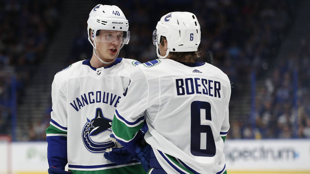 TAMPA, FL - OCTOBER 11: Vancouver Canucks center Elias Pettersson (40) talks to Vancouver Canucks right wing Brock Boeser (6) during the regular season NHL game between the Vancouver Canucks and Tampa Bay Lightning on October 11, 2018 at Amalie Arena in Tampa, FL.