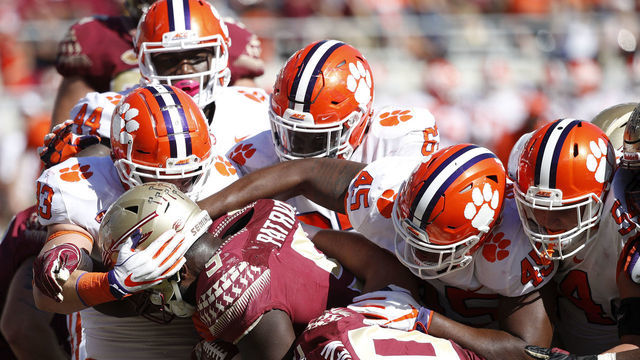 TALLAHASSEE, FL - OCTOBER 27: A group of Clemson Tigers defenders make a tackle for loss against Jacques Patrick #9 of the Florida State Seminoles in the third quarter of the game at Doak Campbell Stadium on October 27, 2018 in Tallahassee, Florida. Clemson won 59-10.