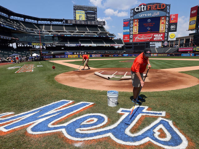 NEW YORK, NY - JULY 16: A grounds crew member paints the Mets logo on the field during the 84th MLB All-Star Game on July 16, 2013 at Citi Field in the Flushing neighborhood of the Queens borough of New York City.