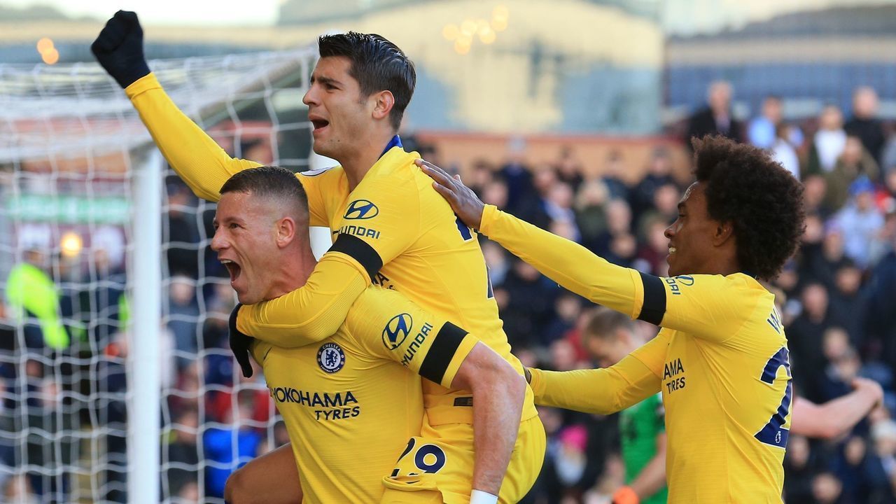 Chelsea's English midfielder Ross Barkley (L) celebrates with Chelsea's Spanish striker Alvaro Morata (C) and Chelsea's Brazilian midfielder Willian (R) after scoring their second goal during the English Premier League football match between Burnley and Chelsea at Turf Moor in Burnley, north west England on October 28, 2018.
