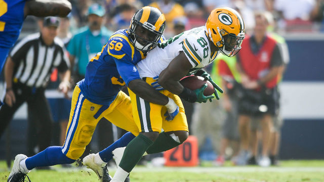 LOS ANGELES, CA - OCTOBER 28: Running back Ty Montgomery #88 of the Green Bay Packers completes a pass in the second quarter in front of linebacker Cory Littleton #58 of the Los Angeles Rams at Los Angeles Memorial Coliseum on October 28, 2018 in Los Angeles, California.