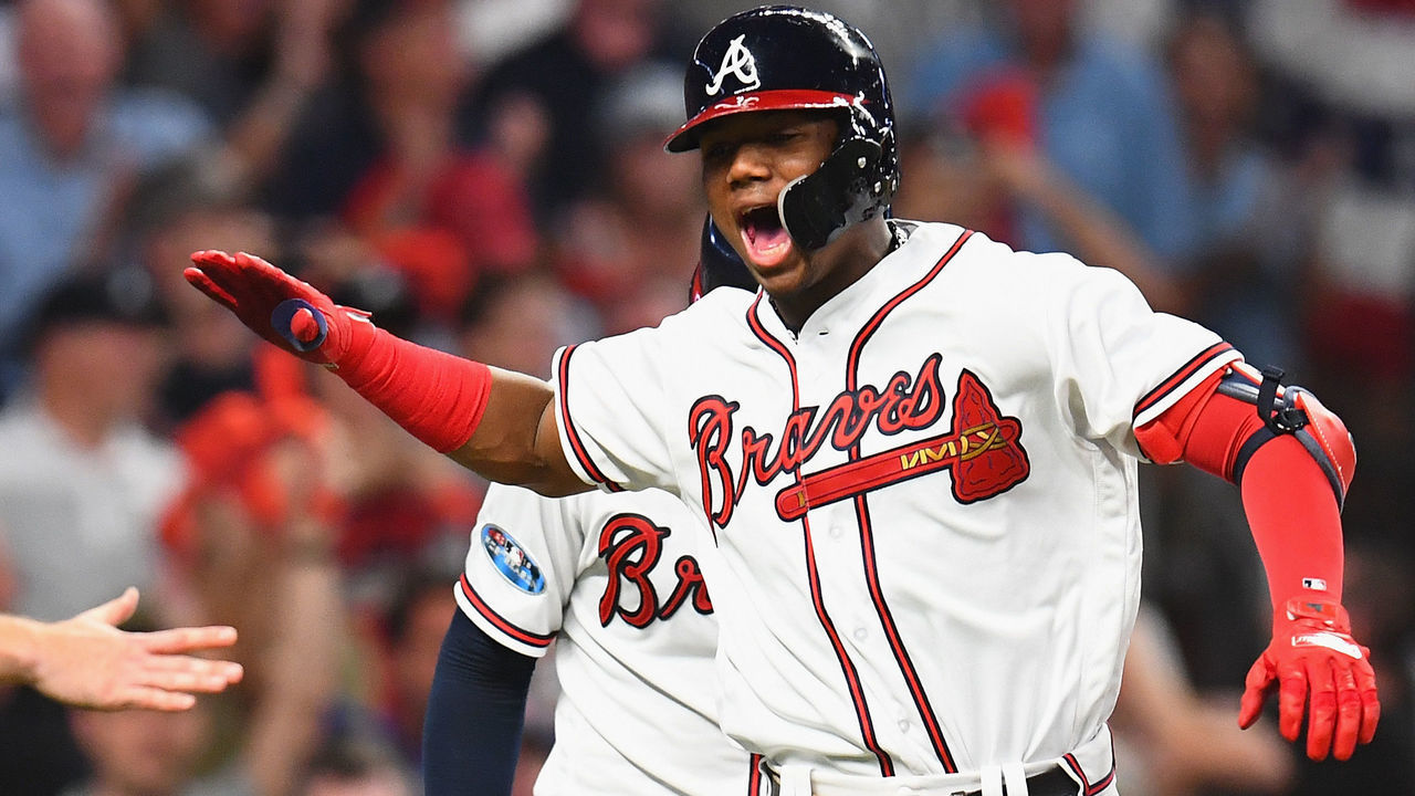 ATLANTA, GA - OCTOBER 07: Ronald Acuna Jr. #13 of the Atlanta Braves celebrates with teammates after hitting a grand slam home run in the second inning against the Los Angeles Dodgers during Game Three of the National League Division Series at SunTrust Park on October 7, 2018 in Atlanta, Georgia.