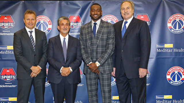 WASHINGTON, DC - AUGUST 4: Scott Brooks, John Wall #2, Ted Leonsis and Ernie Grunfeld of the Washington Wizards pose for a photo after announcing a new contract for John Wall at the Verizon Center in Washington D.C. on August 4, 2017 in Washington, DC.