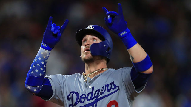 ARLINGTON, TX - AUGUST 29: Yasmani Grandal #9 of the Los Angeles Dodgers celebrates after hitting a solo home run against the Texas Rangers in the top of the eighth inning at Globe Life Park in Arlington on August 29, 2018 in Arlington, Texas.