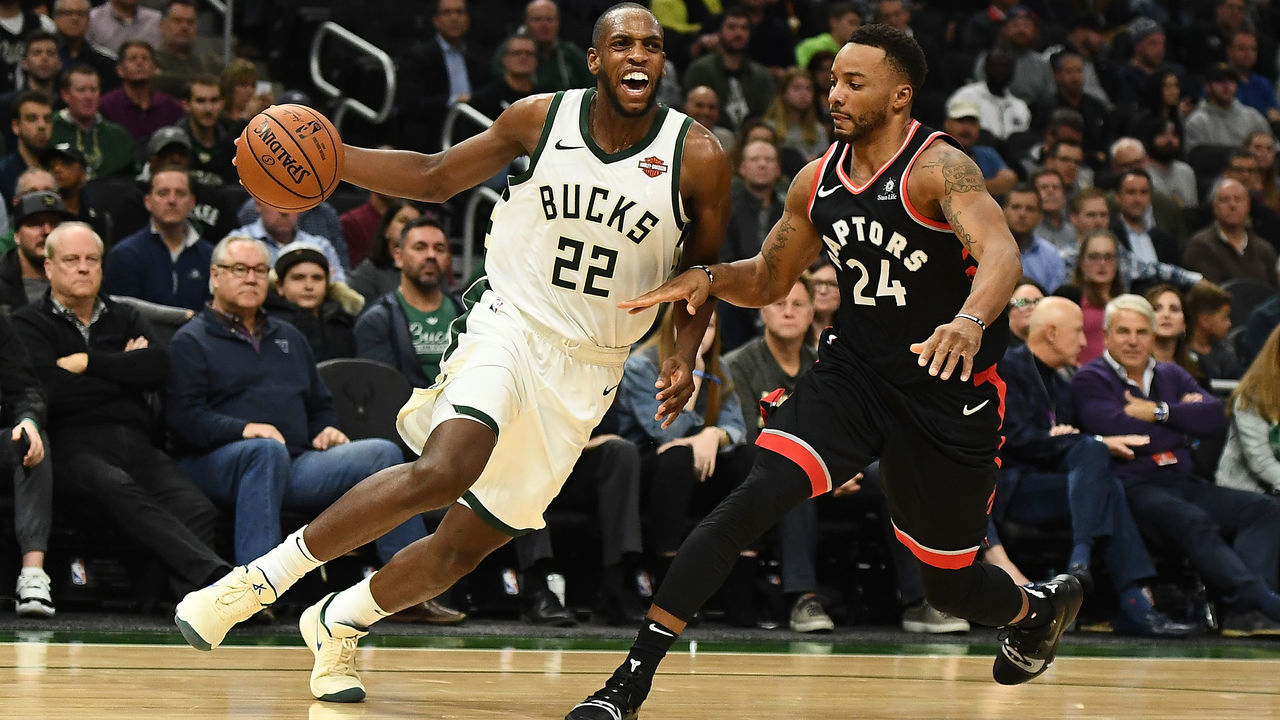 MILWAUKEE, WI - OCTOBER 29: Khris Middleton #22 of the Milwaukee Bucks drives around Norman Powell #24 of the Toronto Raptors during the first half of a game at Fiserv Forum on October 29, 2018 in Milwaukee, Wisconsin.